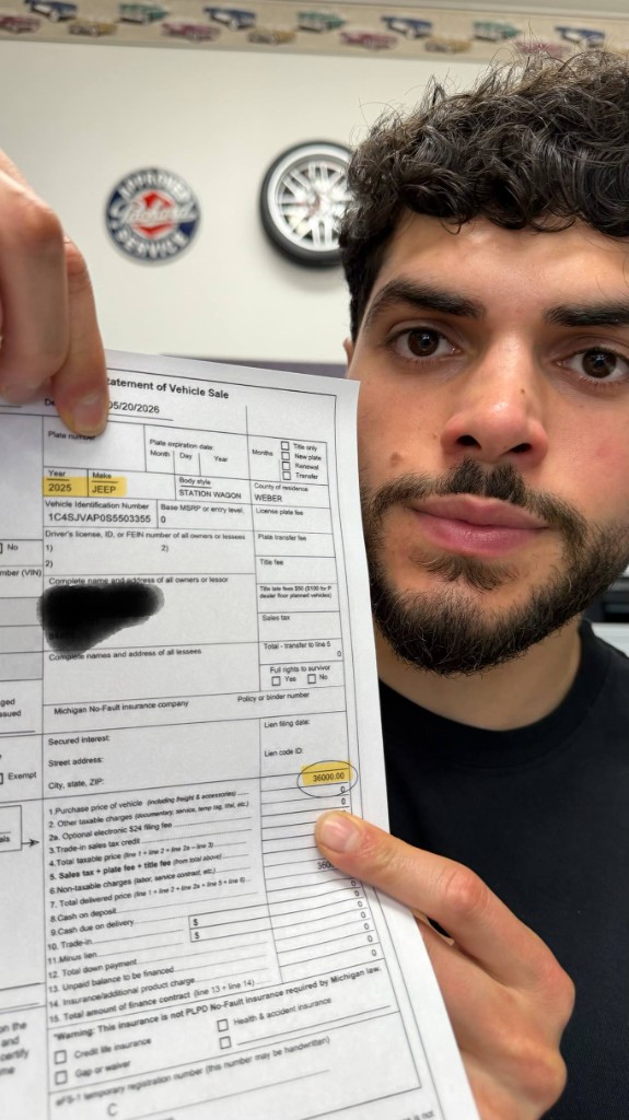 Hussein holding the bill of sale — sold $36,000